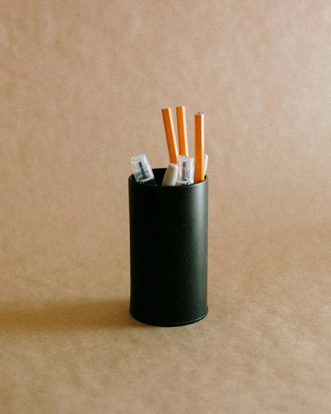 black ceramic mug with cigarette butts